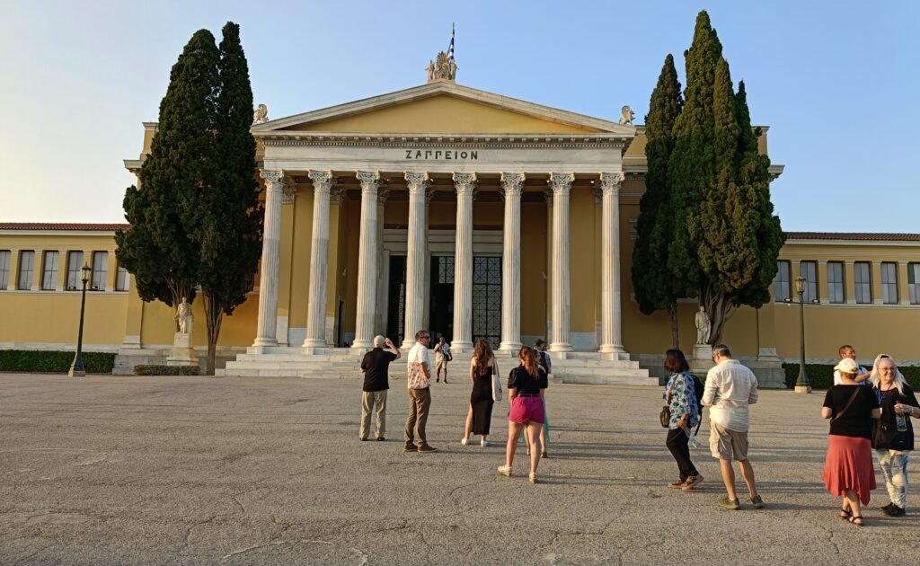Participants walk past the Zappeion Megaron, a landmark situated within the National Garden of Athens Participants walk past the Zappeion Megaron, a landmark situated within the National Garden of Athens