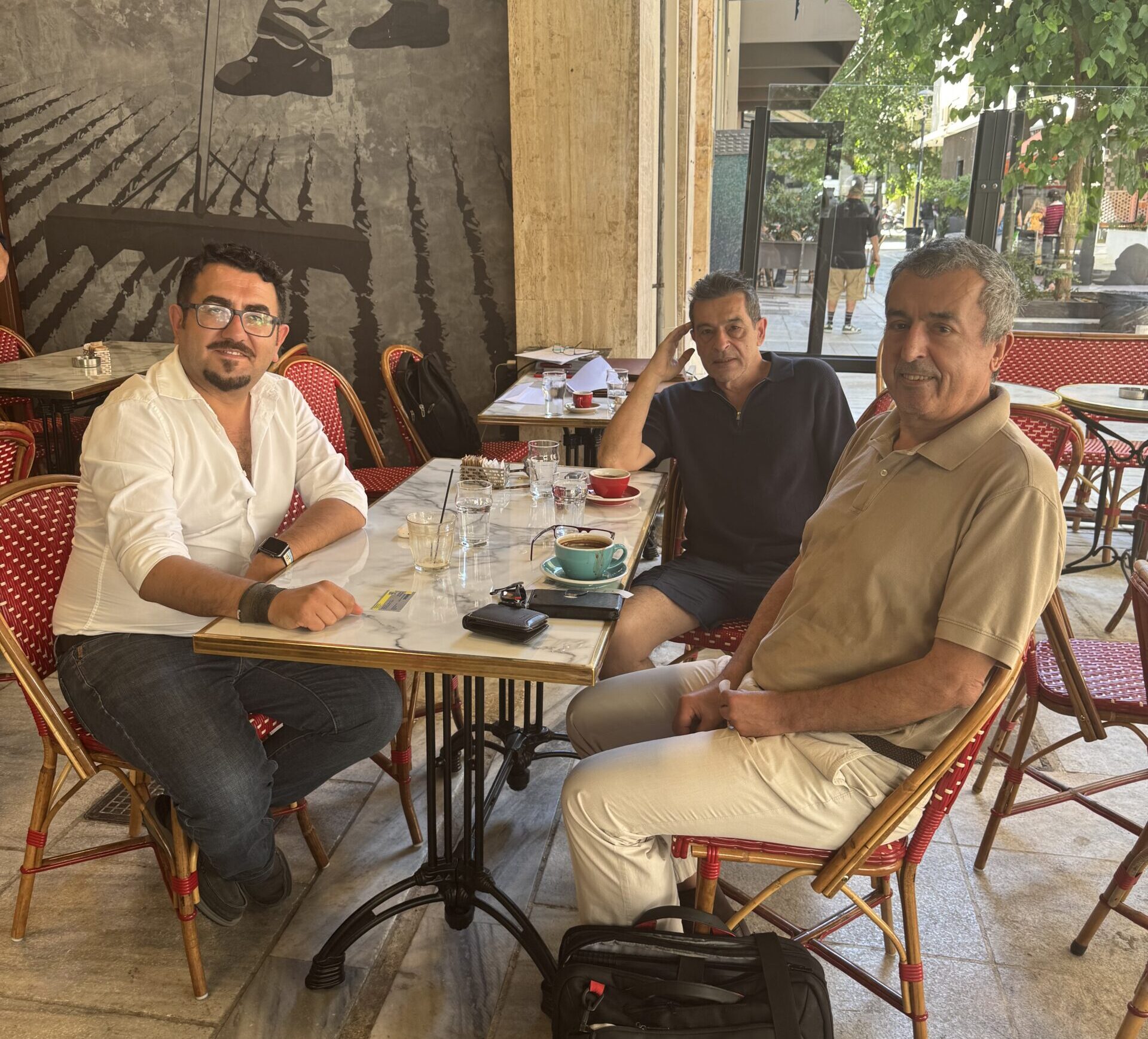 Dr. Gregory T. Papanikos (right); Dr. Chris Sakellariou (center); and Dr. Atlihan Onat Karacali (left) https://www.atiner.gr/wp-content/uploads/2025/07/IMG_6125-scaled-e1752163880679.jpeg